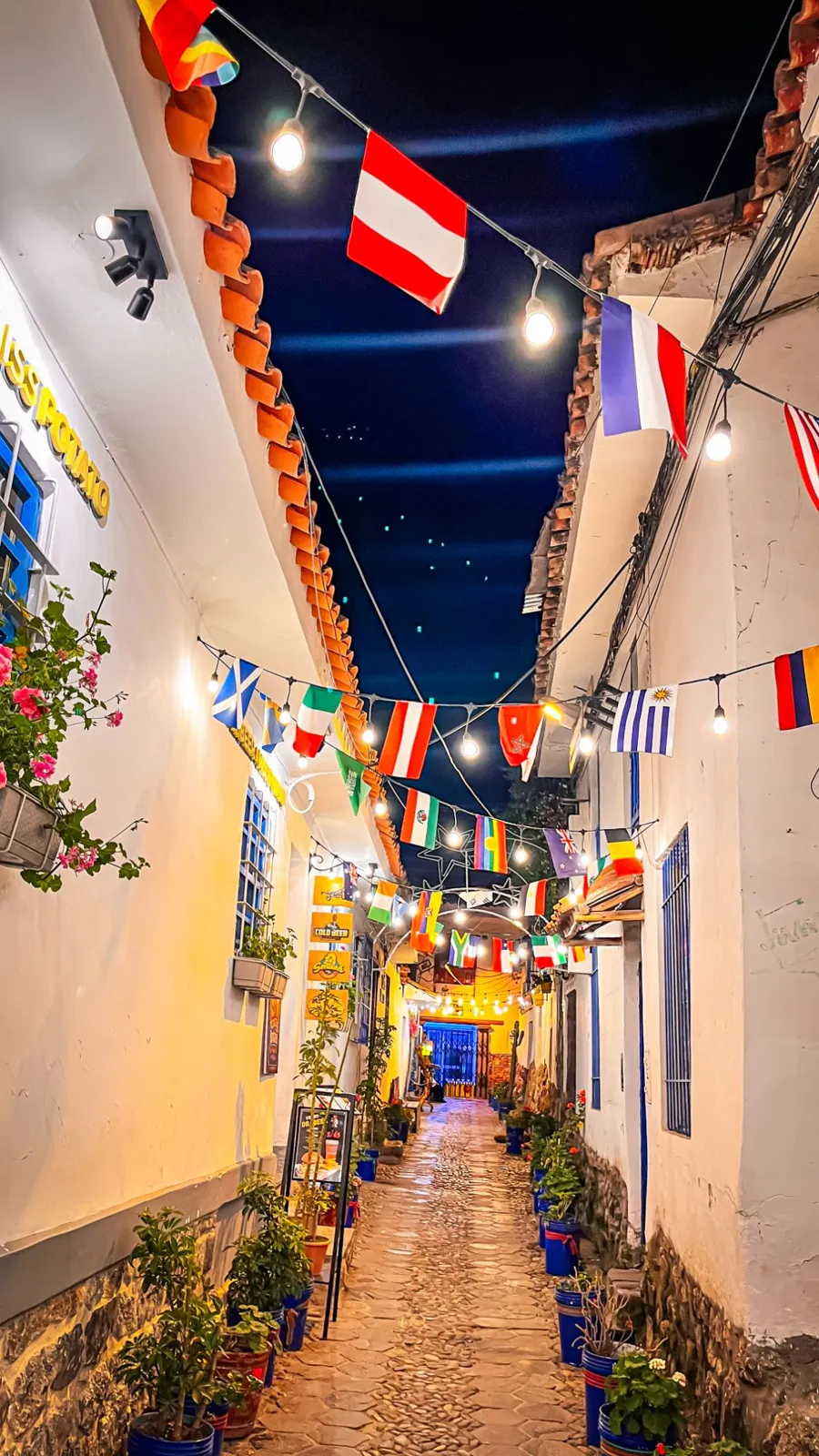Calle de Cusco de noche con faroles y banderas